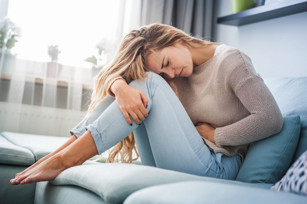 woman struggling with abdominal adhesions